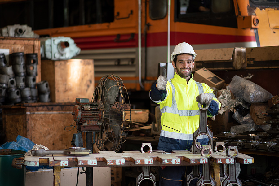 mechanic completing maintenance on a piece of utility equipment